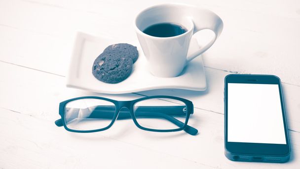 coffee cup with cookie,phone and eyeglasses vintage style - Photo, Image