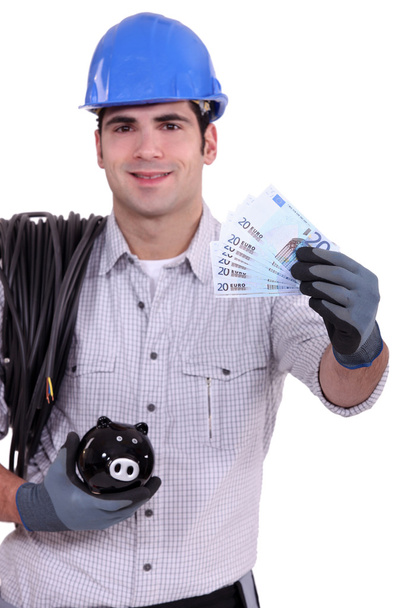Electrician with a piggy bank - Photo, image