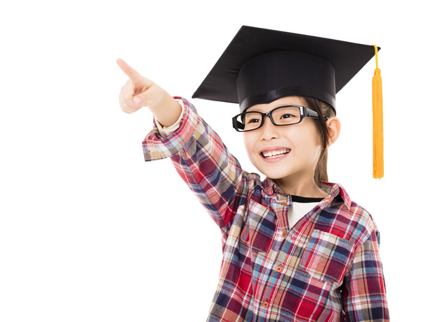 happy school kid in graduation cap with pointing gesture - Photo, Image