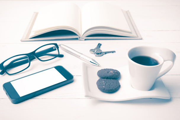 coffee cup with cookie,phone,open notebook,key and eyeglasses vi - Foto, Imagem