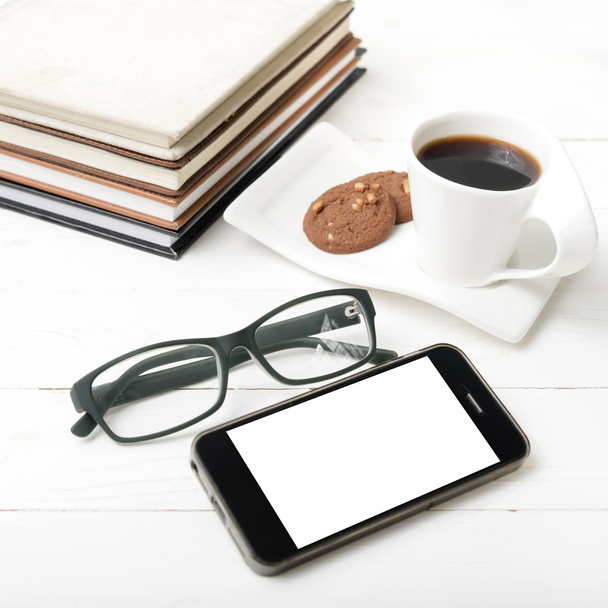 coffee cup with cookie,phone,stack of book and eyeglasses - Foto, Bild