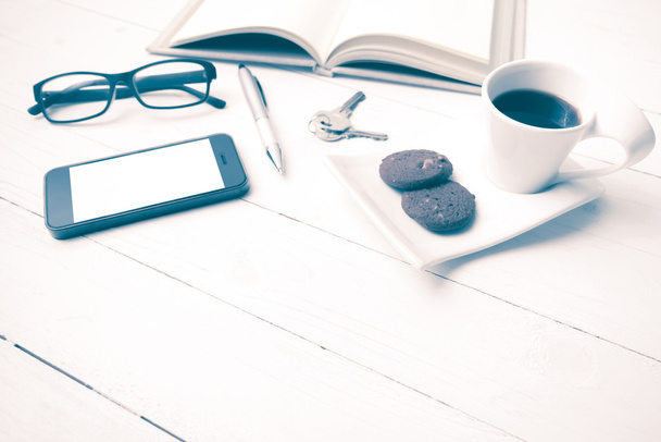 coffee cup with cookie,phone,open notebook,key and eyeglasses vi - Photo, Image