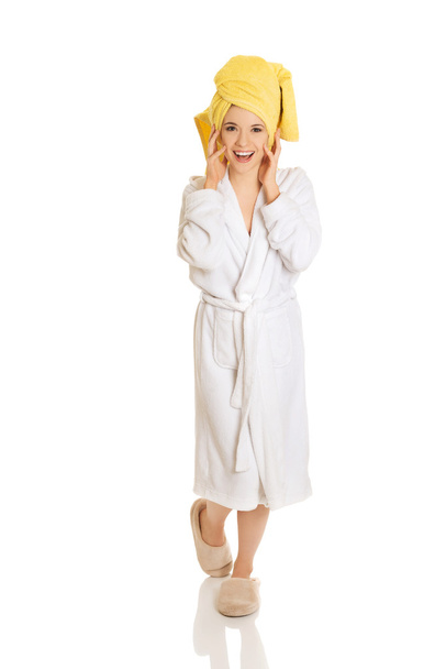 Young smiling woman in bathrobe - 写真・画像