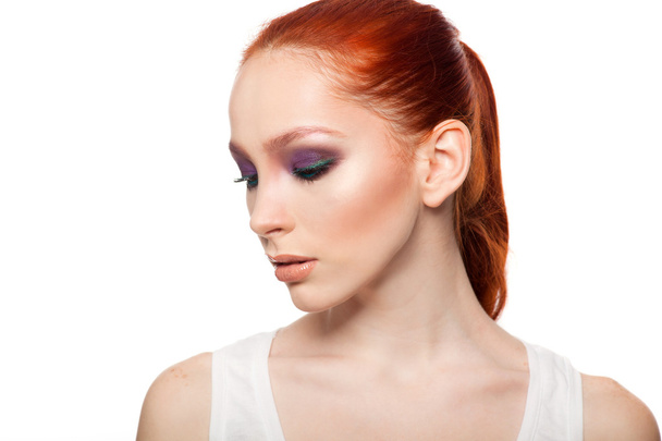 Professional Make-up artist doing glamour with red hair model makeup.  Isolated background. - Foto, immagini