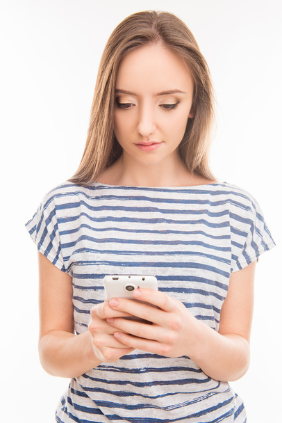 Minded young woman typing sms on mobile phone - Фото, зображення