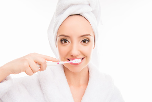 Young cute girl with towel on her head holding toothbrush - Photo, Image