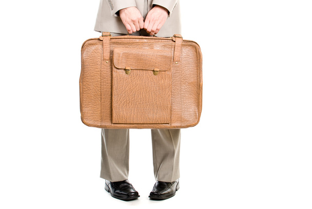 Man holding an old suitcase isolated over white background - Фото, зображення