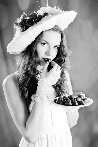 Black and white photography of beautiful elegant lady with chocolate. - Fotó, kép