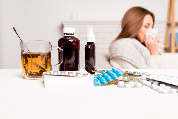 Sick woman, cup of tea, pills and mixture, close up photo - Foto, afbeelding
