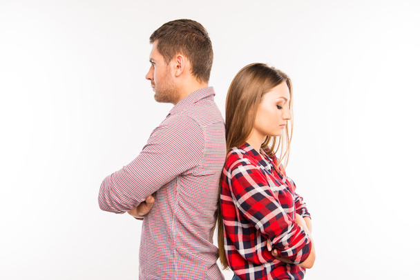Young couple standing back to back ignoring each other - Foto, Bild