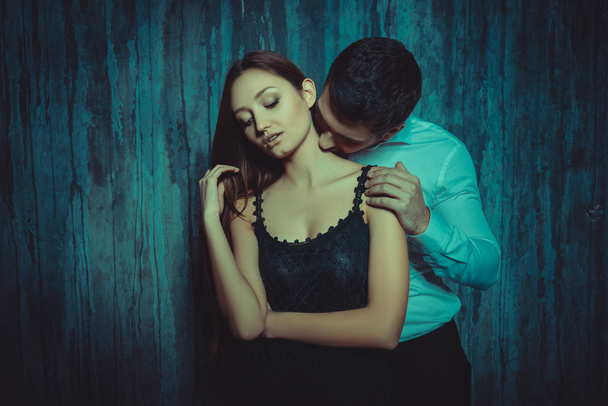 Portrait of man kissing her girlfriend's  neck - Foto, afbeelding
