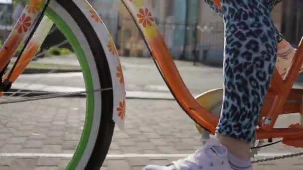 Womans feets and pedals of a bright moving bicycle focus in in summer evening - Footage, Video