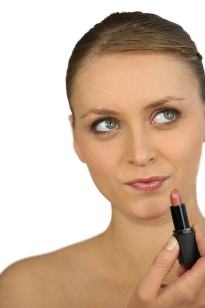 Woman putting on lipstick - Φωτογραφία, εικόνα