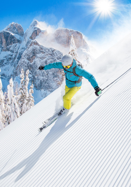 Skier skiing downhill in high mountains - Photo, Image