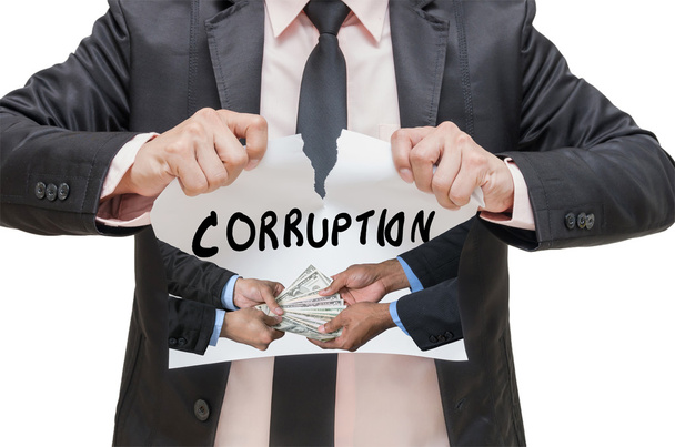 Businessman ripping up the CORRUPTION sign with receiving the money offered between two businessman on white background - Photo, Image