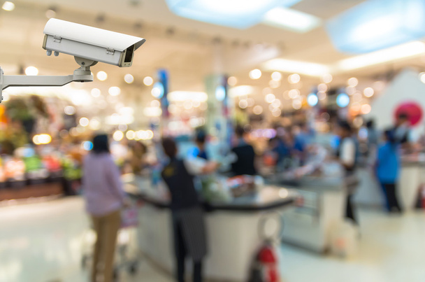 Biztonsági kamera megfigyelő a pénztár store életlenítés háttér bokeh - Fotó, kép