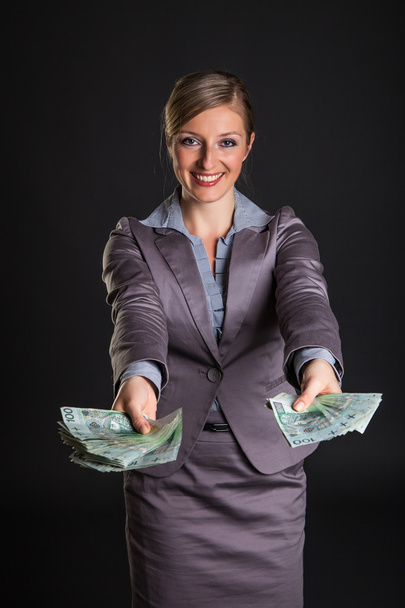 Woman with polish zloty money on dark gray background - Фото, зображення