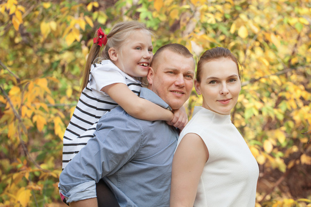 Portrait of happy family in fall park - Zdjęcie, obraz