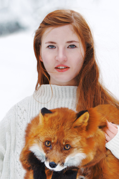 Beautiful girl with red fox on walk - Foto, imagen