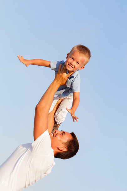 Feliz padre joven con su pequeño hijo al aire libre
 - Foto, imagen
