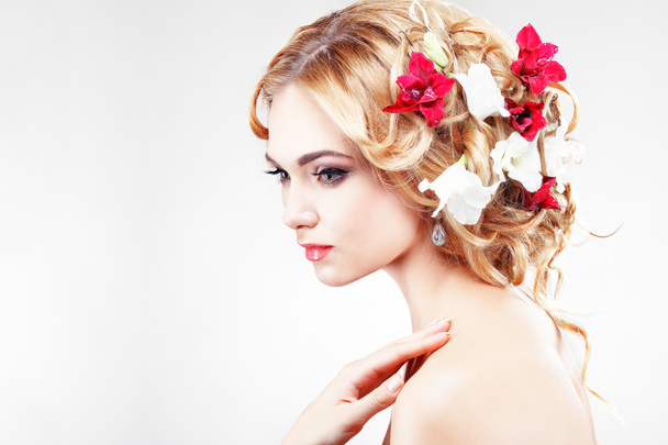Beautiful  girl with varicoloured flowers - Photo, image