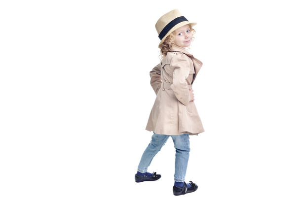 Fashionable child. Blonde girl in a stylish raincoat and hat. - Valokuva, kuva