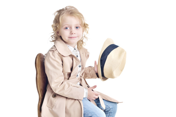 Fashionable child. Blonde girl in a stylish raincoat and hat. - Photo, Image