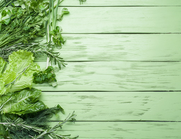 Green herbs on the green wooden background. - Фото, изображение