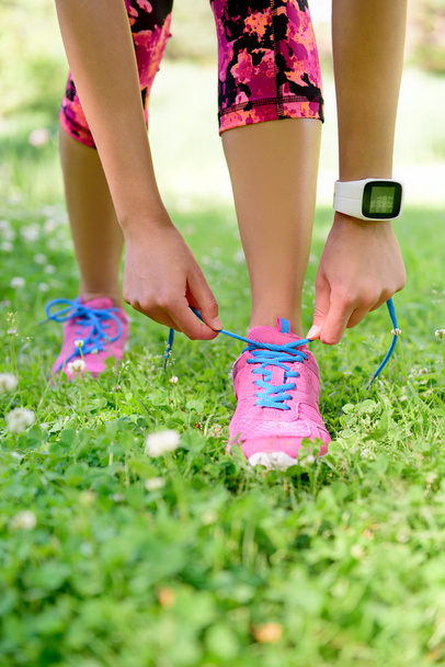 runner tying laces wearing smartwatch - Фото, зображення