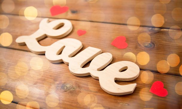 close up of word love with red paper hearts - Фото, изображение