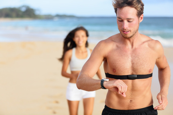 man jogging using heart rate monitor - Fotó, kép
