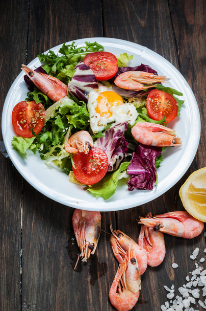 Healthy Shrimp and Arugula Salad with Tomatoes on a wooden table - Photo, Image