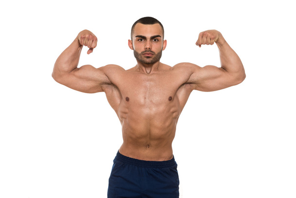 Muscular Bodybuilder Man Posing Over White Background - Foto, Imagen