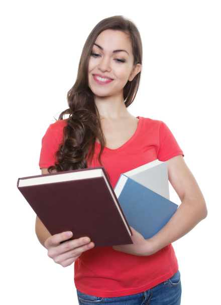 Female student with long dark hair looking at a book - Foto, Bild