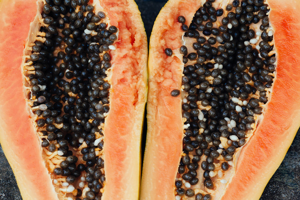 sliced papaya fruit on black background - Valokuva, kuva