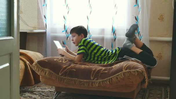 boy teen playing on tablet game - Felvétel, videó