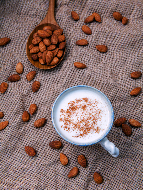Homemade almond milk in the coffee cup with almond - Φωτογραφία, εικόνα