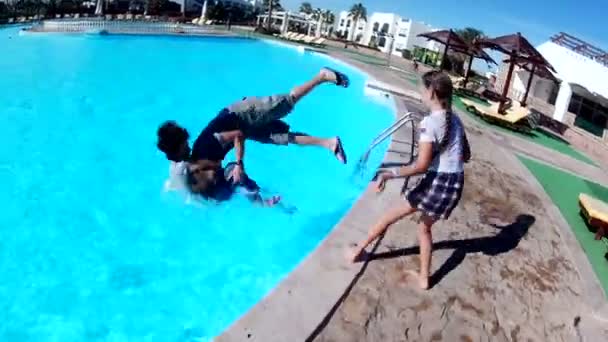 Mom with kids playing and having fun jumping in the pool. - Felvétel, videó