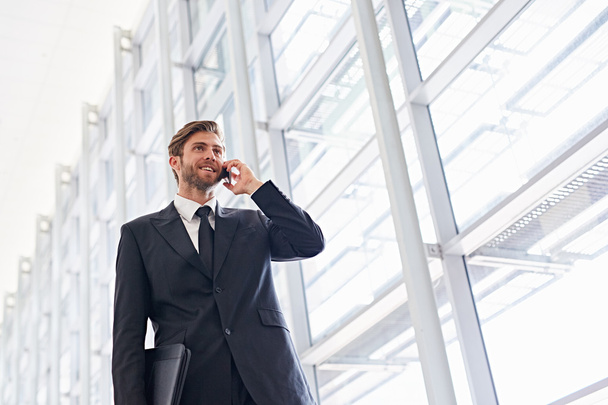 businessman talking on phone walking corridor - Fotografie, Obrázek