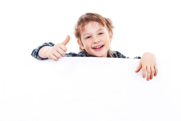 Boy holding a banner isolated on white background - Фото, изображение