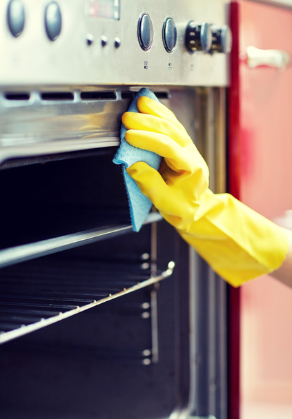 close up of woman cleaning oven at home kitchen - Photo, image