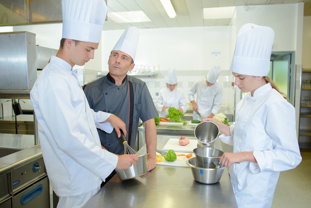 Trainee cooks under the supervision of a chef - Fotó, kép