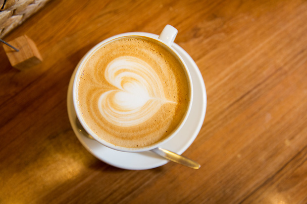 close up of coffee cup with heart shape drawing - Φωτογραφία, εικόνα