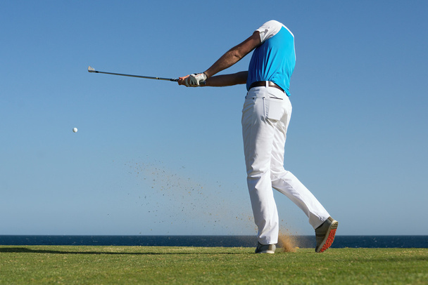 Golfer hitting ball with force - Photo, Image