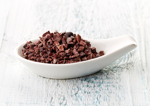 Cacao nibs in porcelain spoon - Photo, Image