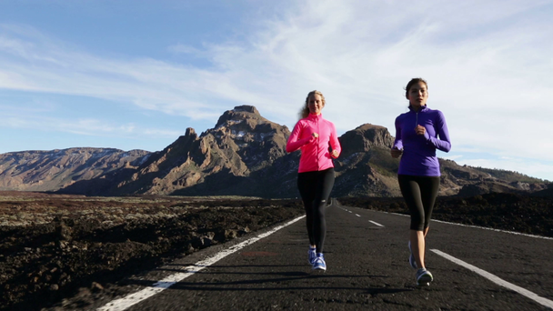 women jogging together on mountain road - Footage, Video