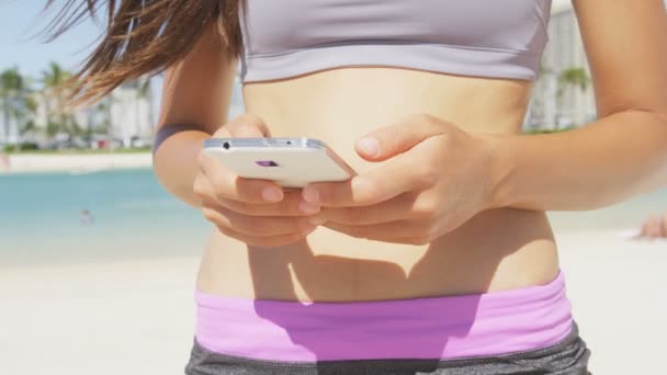 fitness woman using smartphone - Metraje, vídeo