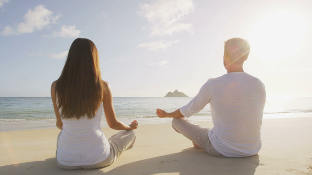 Yoga people meditating on beach - Felvétel, videó