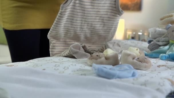 mulher grávida organizando roupas
 - Filmagem, Vídeo