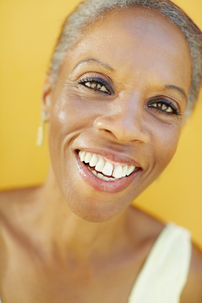 Mature african woman smiling for joy - Foto, afbeelding